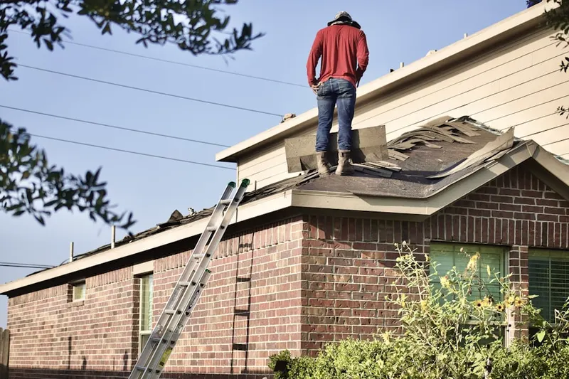 Professional roofer working on a residential roof in Mission Grove